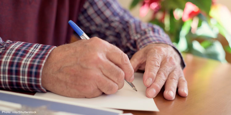 Man signing a card