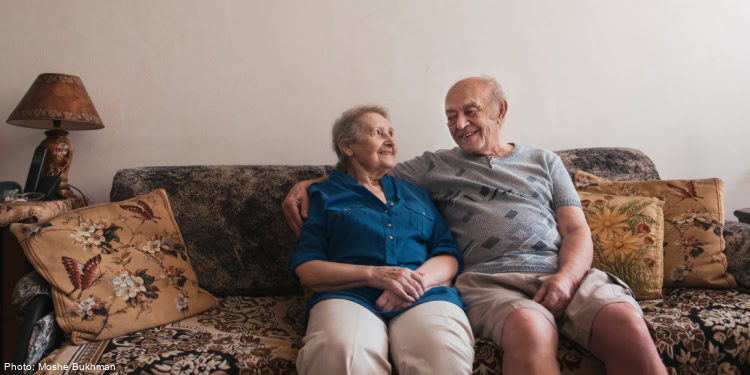 Elderly couple sitting on couch,