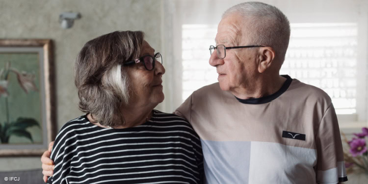 Elderly couple looking at each other