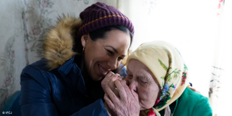 Elderly woman showing gratitude towards Yael