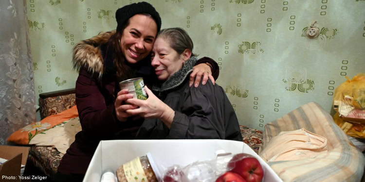Yael hugging elderly woman