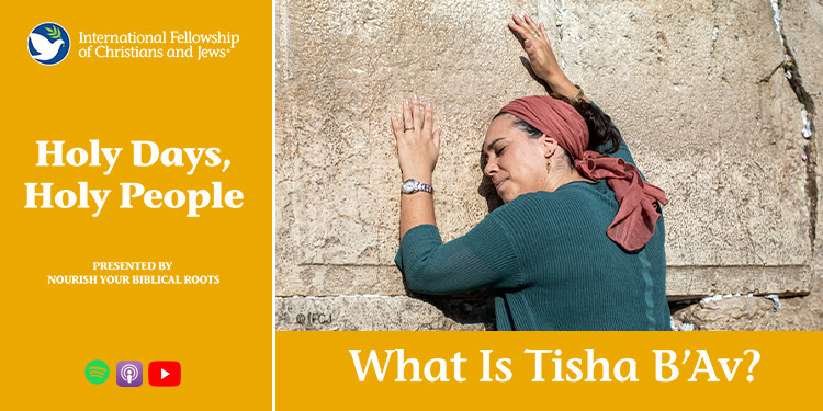 A woman with a headscarf prays at the Western Wall, a sacred site in Jerusalem, during Tisha B'Av, a day of mourning in Jewish tradition.