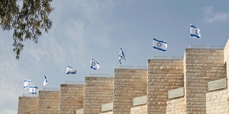 Tall pillars of concrete with the Israeli flags on top of them.
