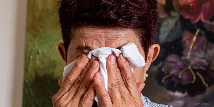 Man covering his face crying