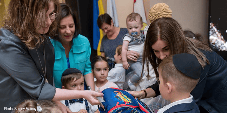 Group of children and adults participating in a charity event organized by IFCJ, showing compassion and support for children in need.