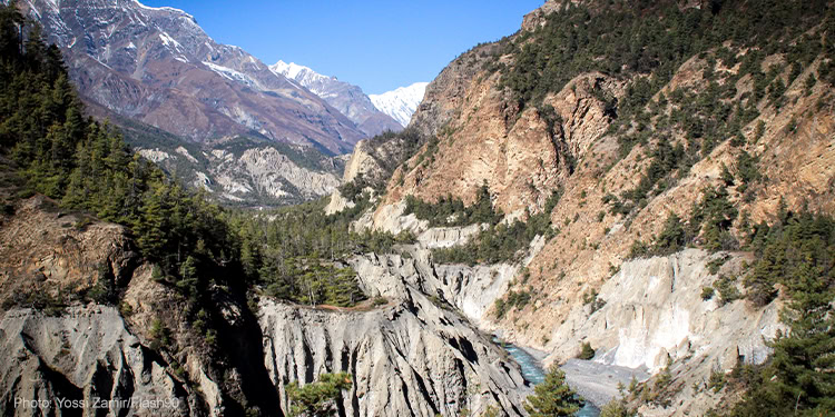 Travellers hike the Annapurna Circuit- a trek within the mountain ranges of central Nepal