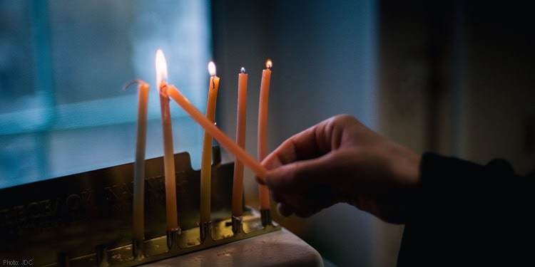 Lighting Hanukkah candles