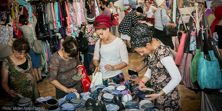 Orthodox Jewish women enjoy shopping at a conference.