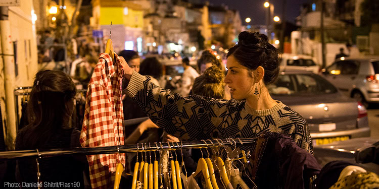 Young Israelis shop at a second hand market in the Jerusalem neighborhood of Nachlaot