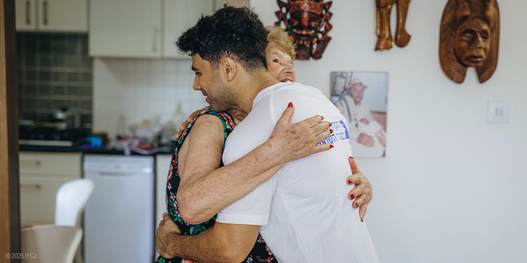IFCJ Staff hugging elderly woman