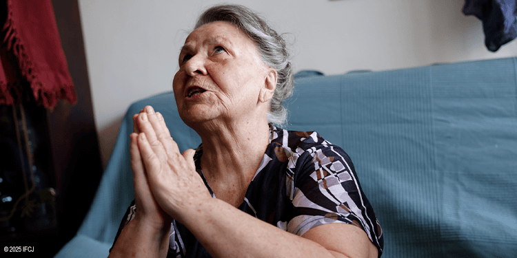 Elderly woman praying