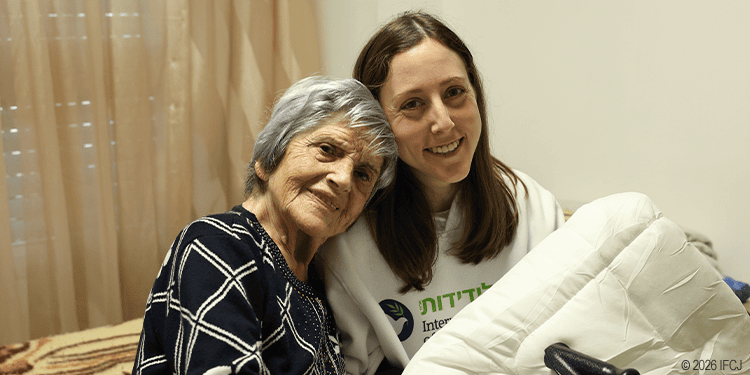 An elderly woman receiving compassionate care from a young caregiver, symbolizing love and support in times of need.
