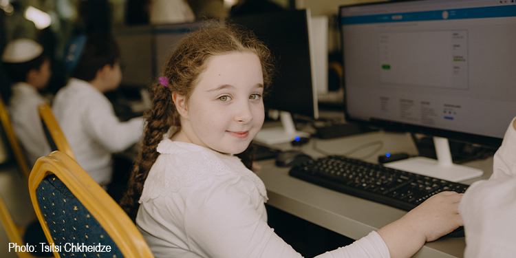 Little girl sitting at a desk