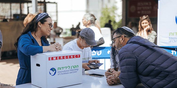 Volunteers and community members engaging at an IFCJ charity event focused on compassion and support.