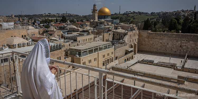 Jews pray on the rooftop of an apartment overlooking the Western Wall plaza in Jerusalem’s Old City