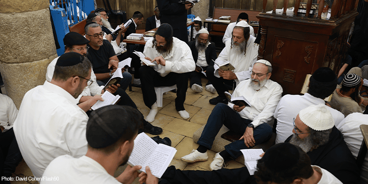 Jewish men praying on Tisha B Av