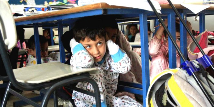 Israeli children taking cover under school desks