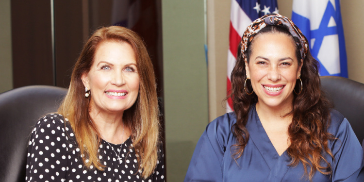 Yael Eckstein and Michelle Bachmann sitting next to each other at a meeting table