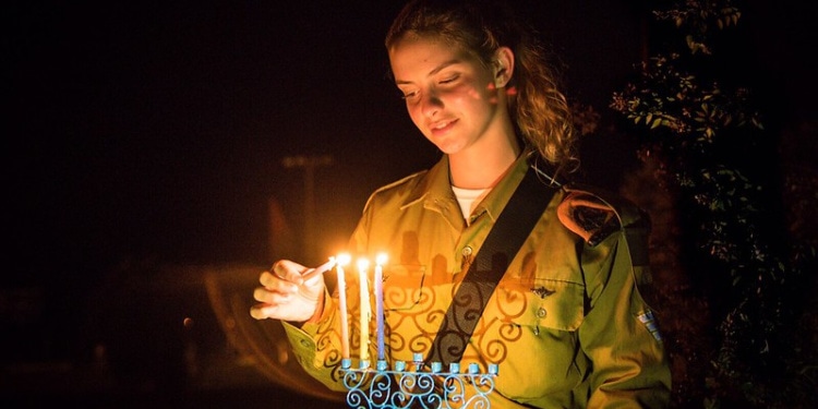 IDF soldier lights menorah for Hanukkah, the Festival of Dedication