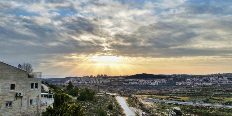 Sunrise looking over land and buildings on Israel.