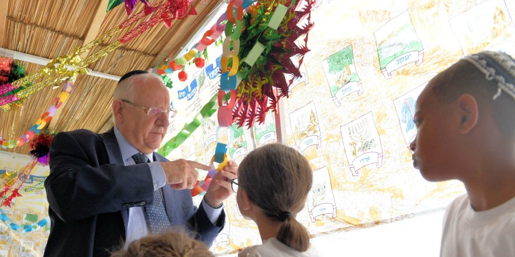 Reuven Rivlin in sukkah with Israeli children