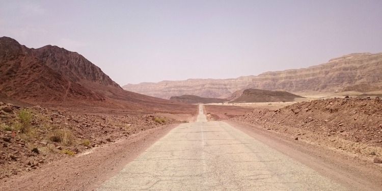 A long road leading into the desert.