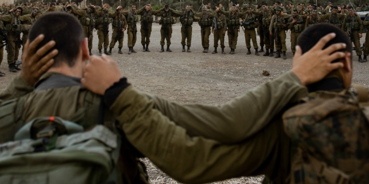 IDF soldiers in a soldier holding on to each other.