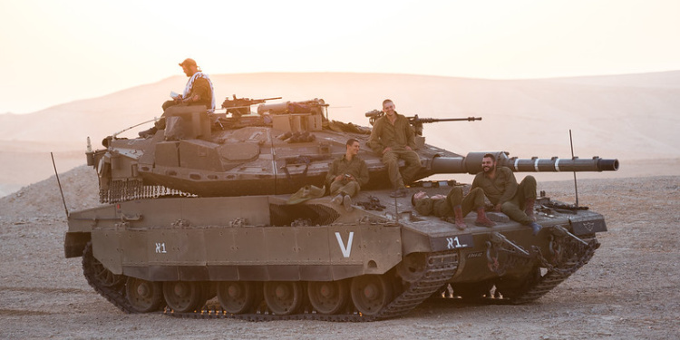 IDF tank crew members fix tefillin to pray