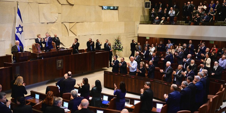Mike Pence giving a speech at a podium in front of a crowd of people in Knesset.