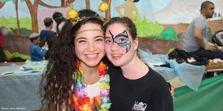 Two women dressed up in Purim costumes.