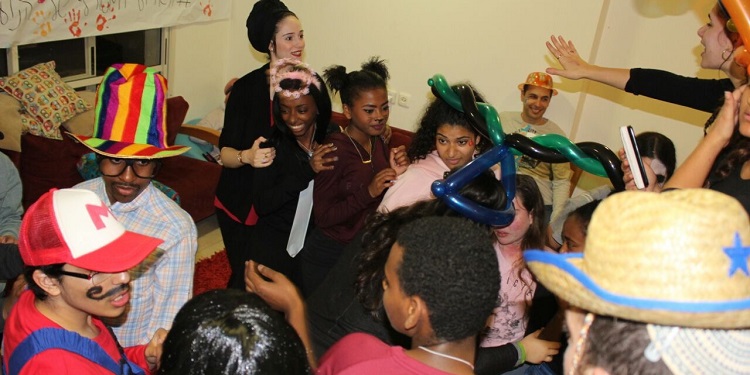 Several dancing together at a Purim party.