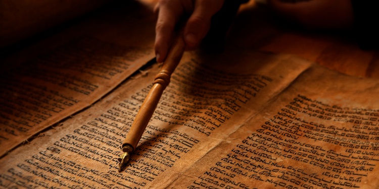Close up image of a person going through the Torah.