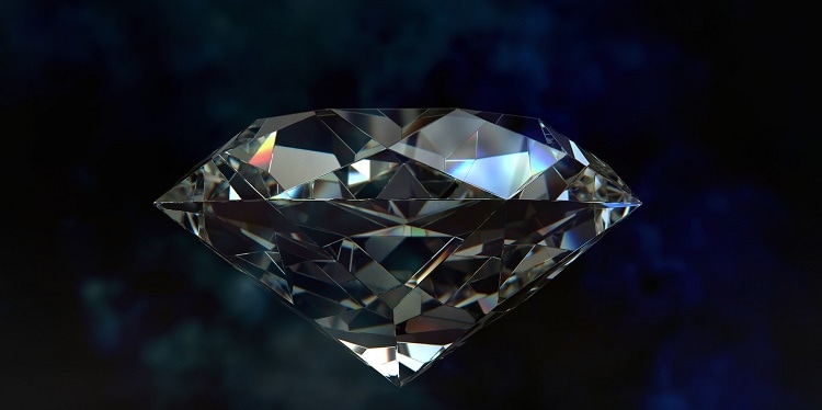 Close up image on a large diamond against a blue black background.