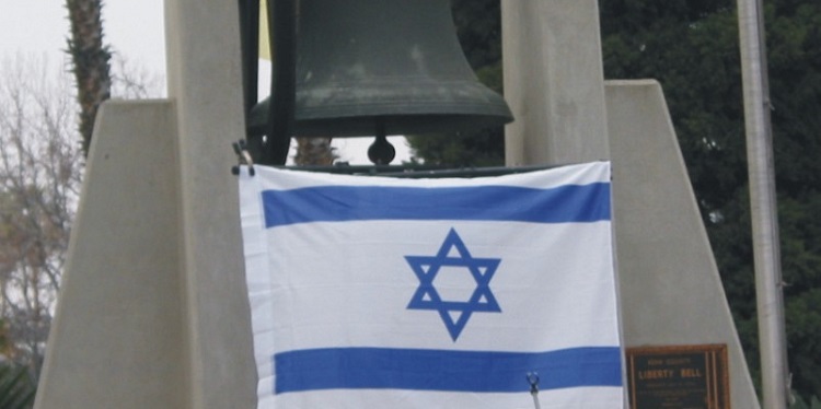Israeli flag flying below a Liberty Bell.