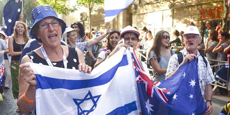 Group of individuals carrying the flag of Israel at the Jerusalem March in Australia
