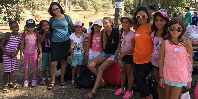 Two camp counselors with their group at a Sukkot day camp for orphans.