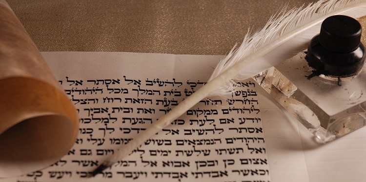 Hebrew words written on a white piece of paper with a feather pen.