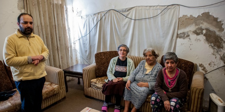 Four Iraqi Christian refugees sitting in a living room.