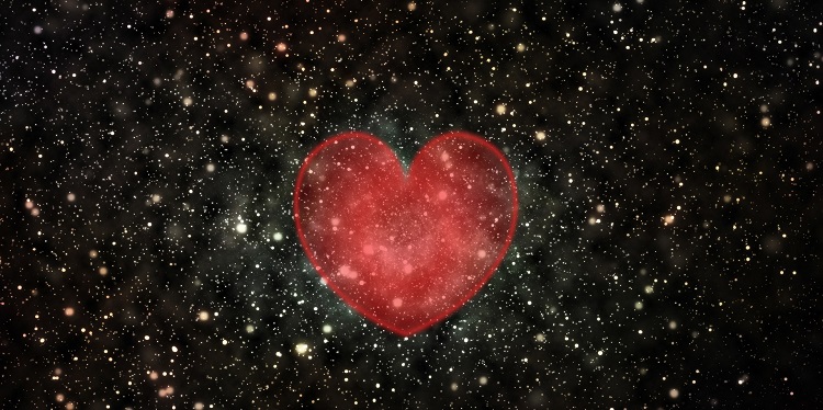 Animated image of a heart amongst a starry black sky.