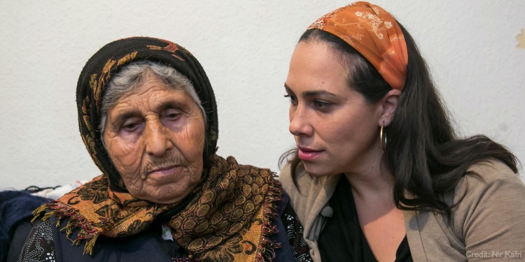 Yael with elderly woman, blue sweater