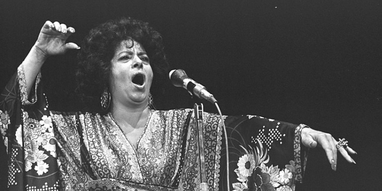 Black and white image of Shoshana Damari singing.