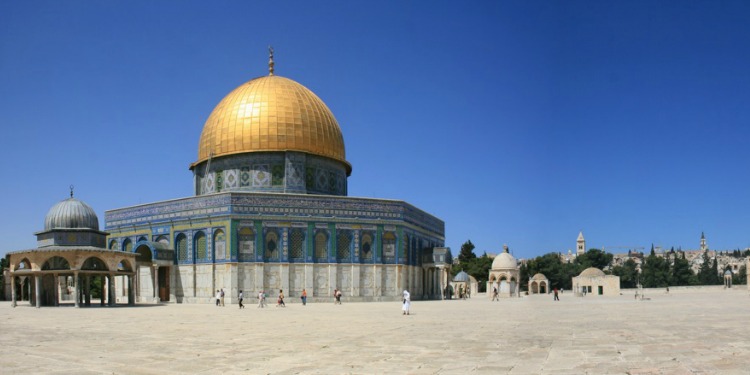 Several people walking around the Temple Mount.