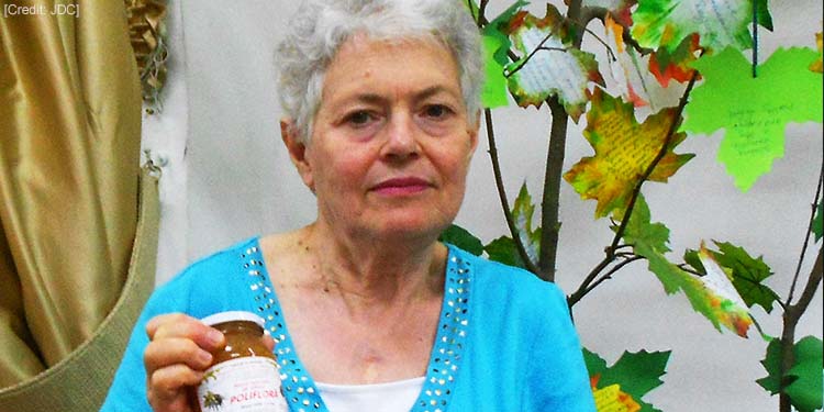 A widow receiving a basket of honey for blessing for the New Year.