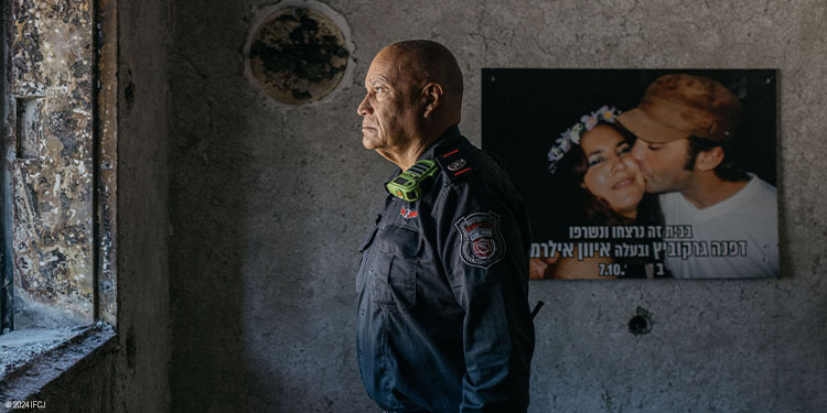 A firefighter looking out of a window
