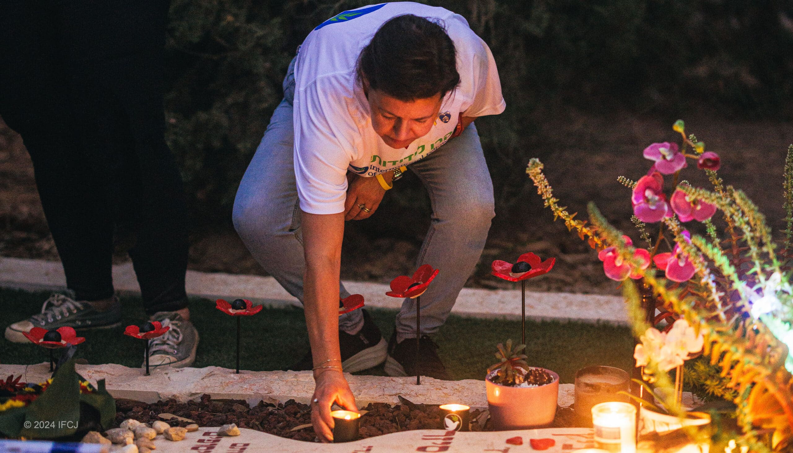 A man a the grave of a victim from the October 7th attack