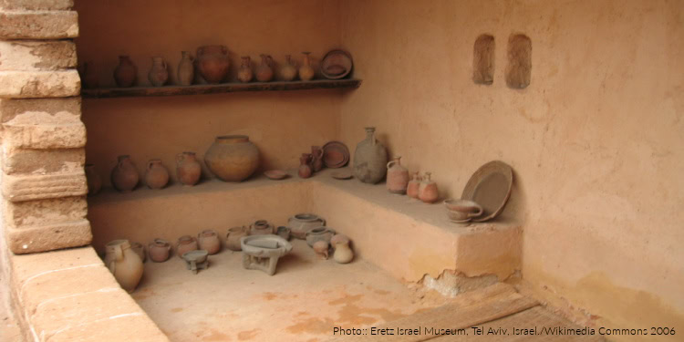 Exhibit of ancient pottery artifacts displayed on shelves at the Eretz Israel Museum in Tel Aviv, showcasing historical craftsmanship.