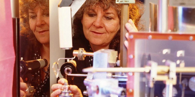 Close up image of a woman using a machine.