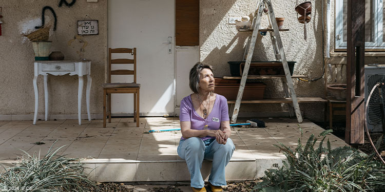 Adele Raemer sitting on her doorstep in Kibbitz