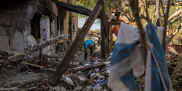 Man cleaning up rubble from the October 7th attack