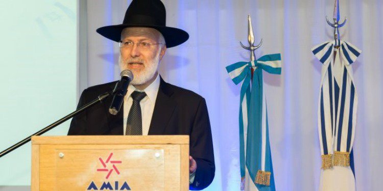 Rabbi speaking at a podium.